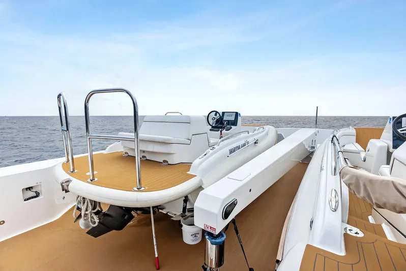 Northland Yacht Photos Pics 2017 Burger 104 Motor Yacht deck with tender, ocean view, and clear sky.