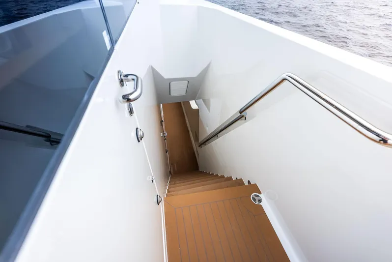 Northland Yacht Photos Pics Staircase on 2017 Burger 104 Motor Yacht, leading below deck with ocean view.