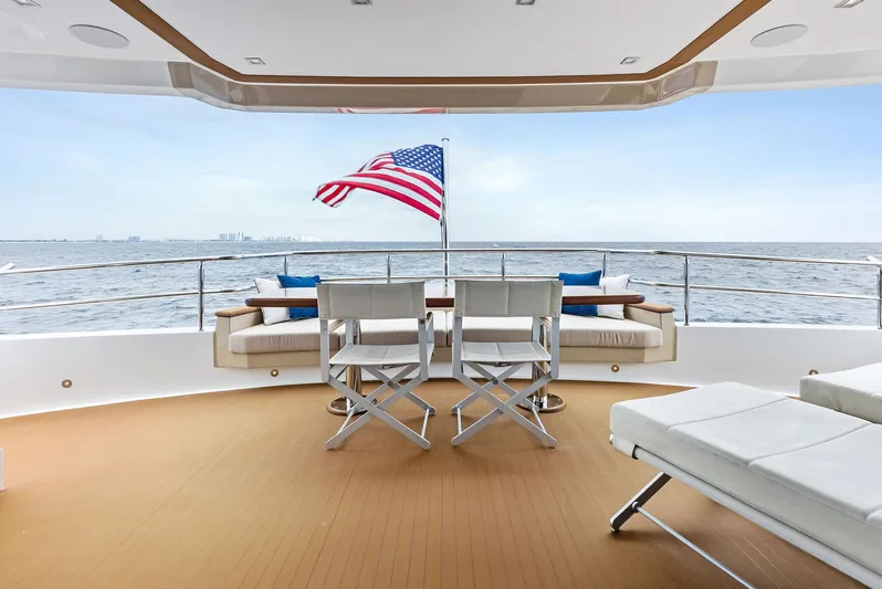 Northland Yacht Photos Pics Luxurious 2017 Burger 104 Motor Yacht deck with seating, ocean view, and American flag.