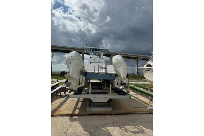  Yacht Photos Pics 2021 Twin Vee 280 CC GF boat with dual outboard motors on a lift.