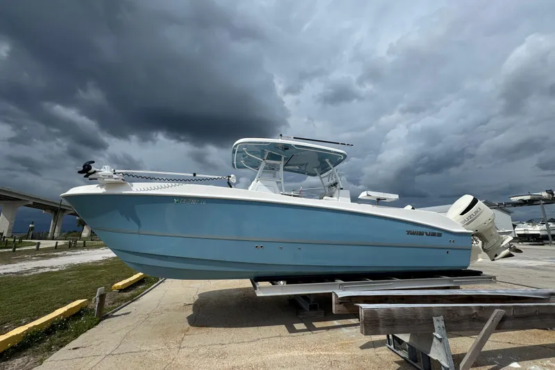  Yacht Photos Pics 2021 Twin Vee 280 CC GF boat on trailer under cloudy sky.