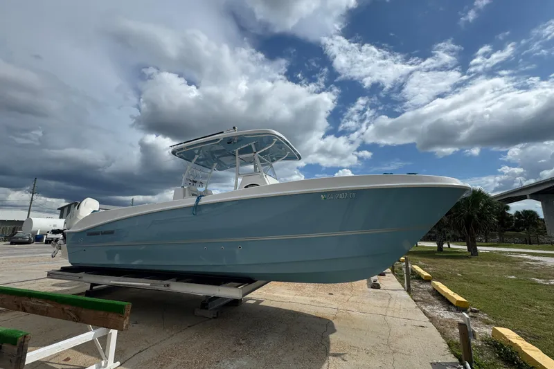  Yacht Photos Pics 2021 Twin Vee 280 CC GF boat on trailer under cloudy sky.