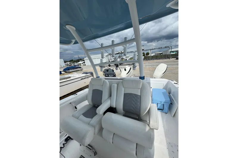  Yacht Photos Pics 2021 Twin Vee 280 CC GF boat interior with cushioned seating and overhead canopy.