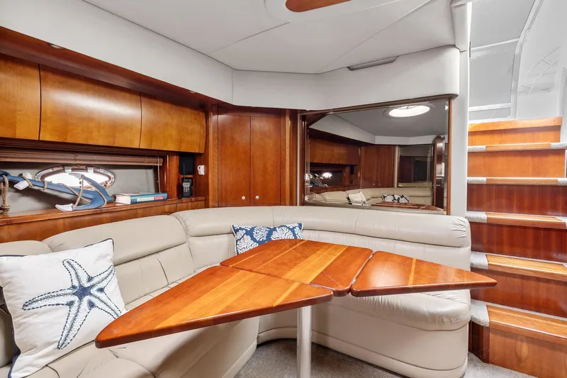  Yacht Photos Pics Luxurious interior of 2007 Cruisers Yachts 520 Express with wooden table and leather seating.