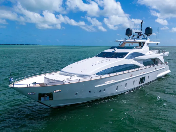  Yacht Photos Pics Luxurious 2012 Azimut Grande 105 yacht cruising on clear blue waters under a sunny sky.