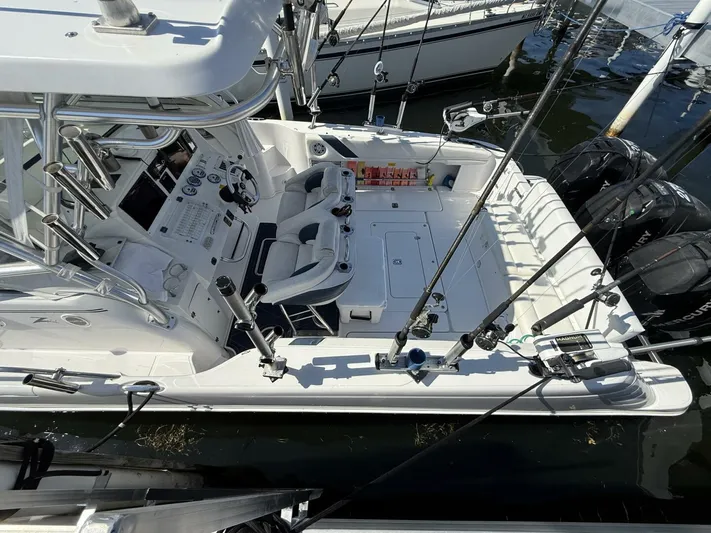  Yacht Photos Pics 2007 Donzi 38 ZSF boat docked, featuring fishing rods and dual outboard motors.