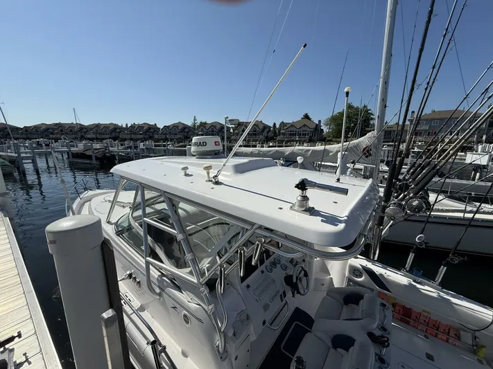  Yacht Photos Pics 2007 Donzi 38 ZSF boat docked at marina with fishing rods and clear sky.