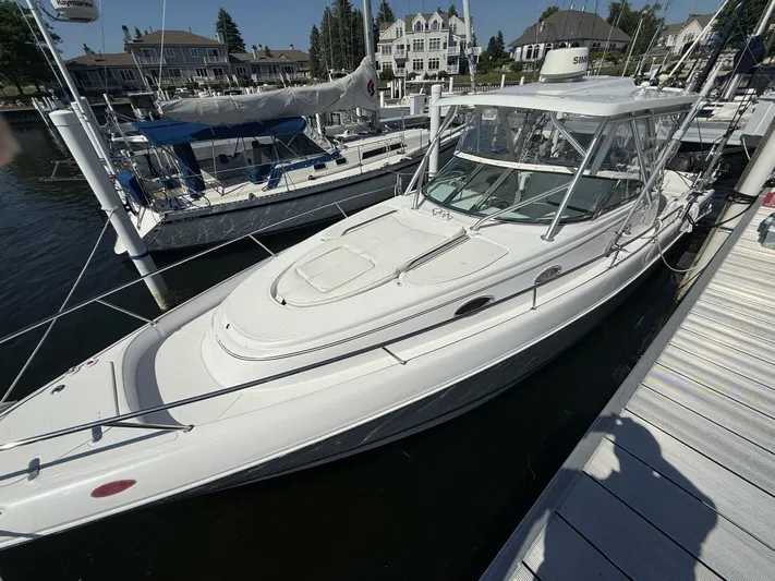  Yacht Photos Pics 2007 Donzi 38 ZSF boat docked at marina, surrounded by other vessels and waterfront homes.