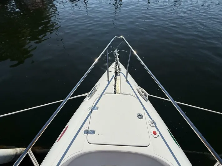  Yacht Photos Pics 2007 Donzi 38 ZSF boat bow with stainless steel railings on calm water.