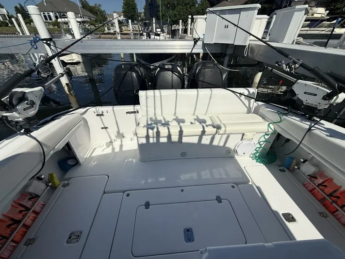  Yacht Photos Pics 2007 Donzi 38 ZSF boat interior with fishing rods and seating at a marina.