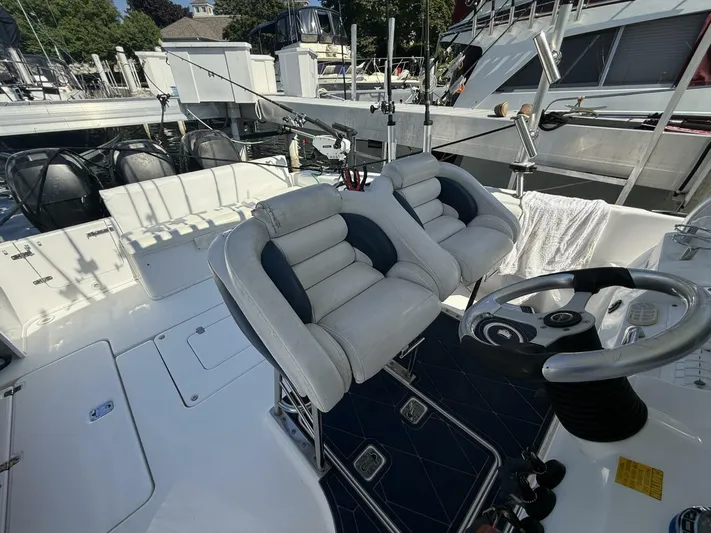  Yacht Photos Pics 2007 Donzi 38 ZSF boat interior with dual seats and steering wheel at a marina.