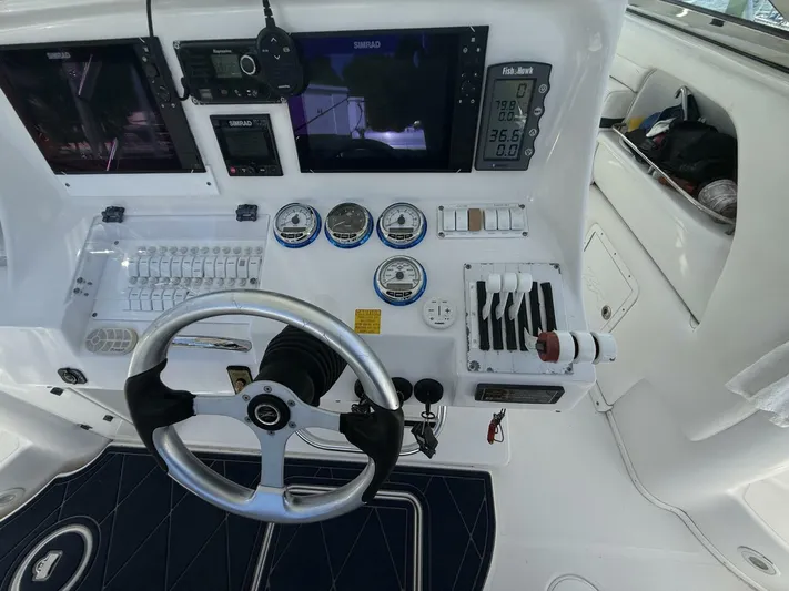  Yacht Photos Pics 2007 Donzi 38 ZSF boat dashboard with steering wheel, gauges, and navigation controls.