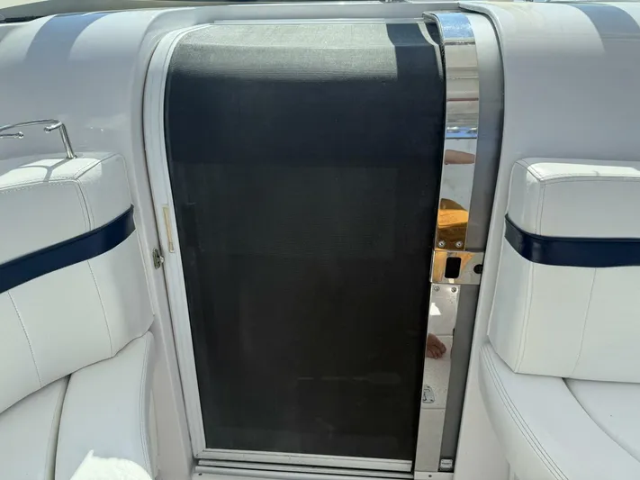  Yacht Photos Pics 2007 Donzi 38 ZSF boat interior with white seating and a black door.
