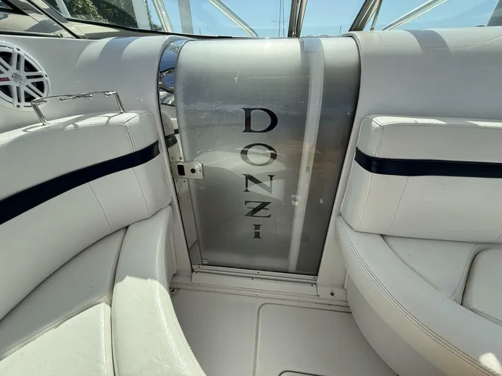  Yacht Photos Pics Interior of a 2007 Donzi 38 ZSF boat with white seating and branded door.