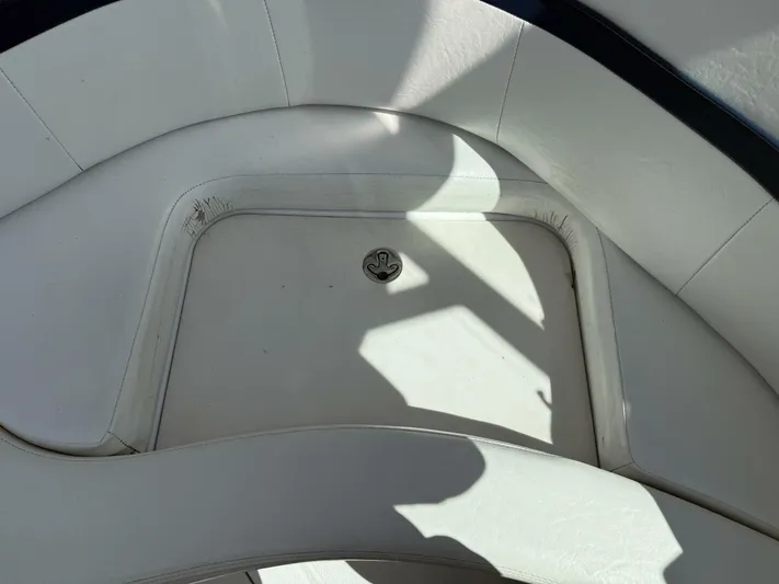  Yacht Photos Pics 2007 Donzi 38 ZSF boat interior with white cushioned seating and storage compartment.