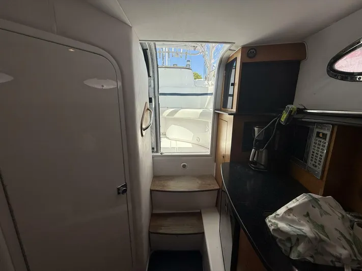  Yacht Photos Pics Interior of 2007 Donzi 38 ZSF boat with kitchenette and stairs leading outside.