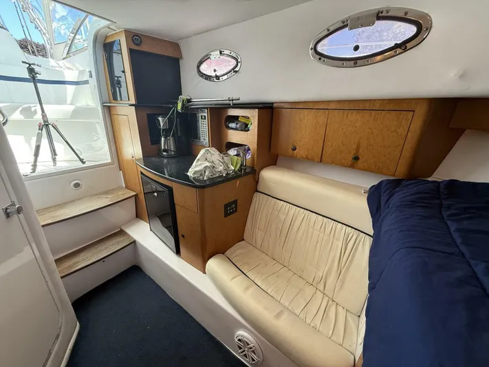  Yacht Photos Pics 2007 Donzi 38 ZSF cabin interior with kitchenette, seating, and portholes.
