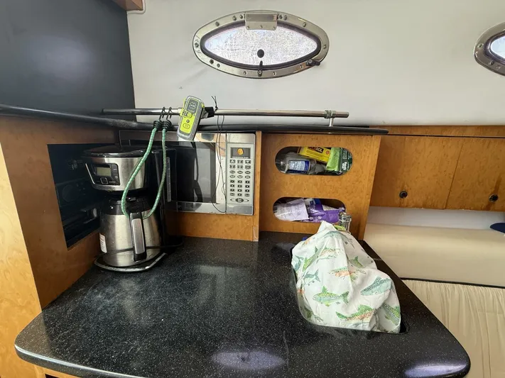  Yacht Photos Pics 2007 Donzi 38 ZSF cabin interior with coffee maker, microwave, and storage shelves.