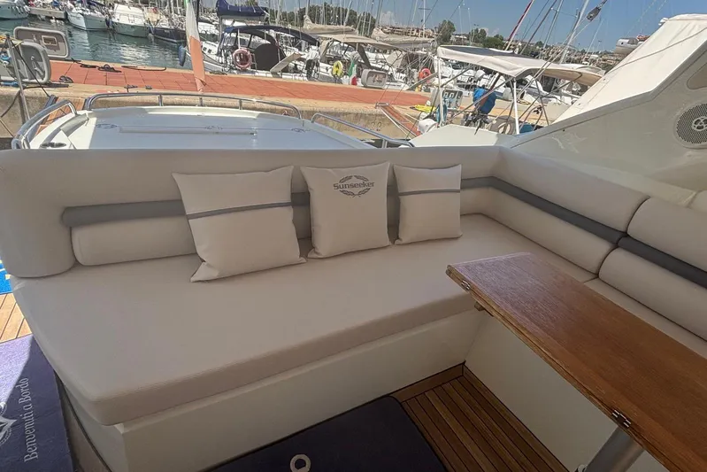  Yacht Photos Pics Luxurious Sunseeker Portofino 48 yacht interior with plush seating and wooden table, 2010 model.