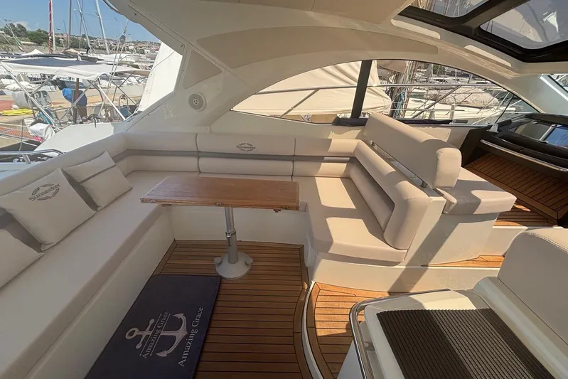  Yacht Photos Pics Luxurious interior of 2010 Sunseeker Portofino 48 yacht with elegant seating and wooden accents.