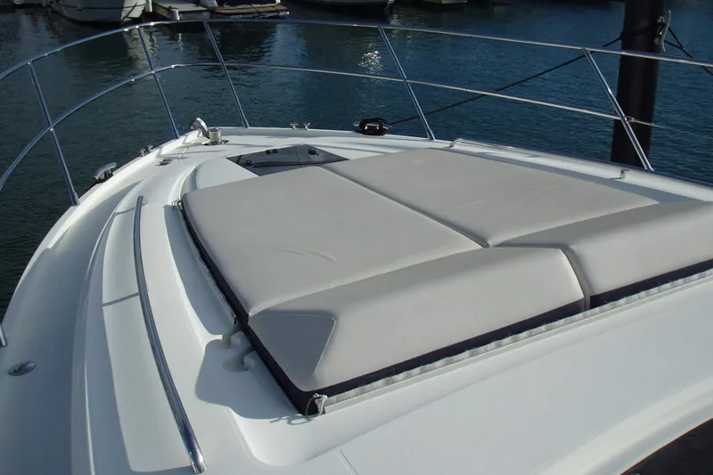 Off Season Yacht Photos Pics 2015 Princess V48 yacht with sunbathing area on deck, docked at marina.
