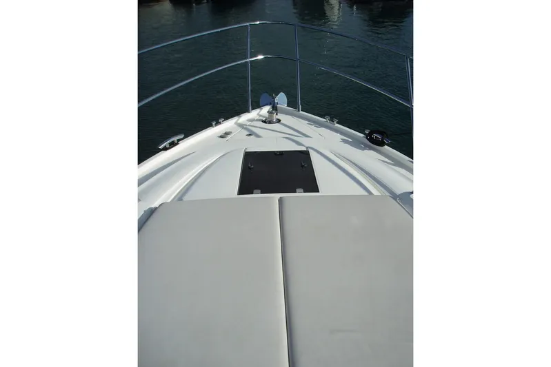 Off Season Yacht Photos Pics Bow view of 2015 Princess V48 yacht with sunpad and railing.