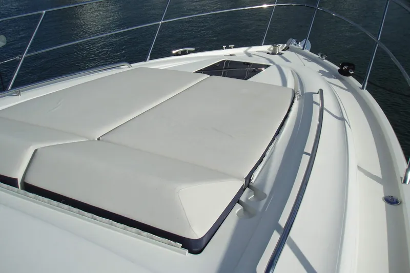 Off Season Yacht Photos Pics 2015 Princess V48 yacht with sunbathing deck, sleek design, and stainless steel railings.