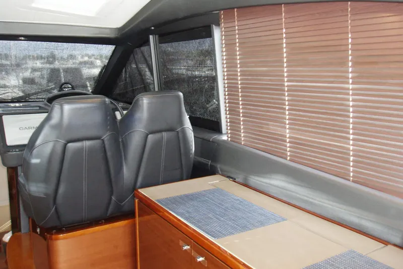 Off Season Yacht Photos Pics Interior of 2015 Princess V48 yacht with leather seats and wooden blinds.