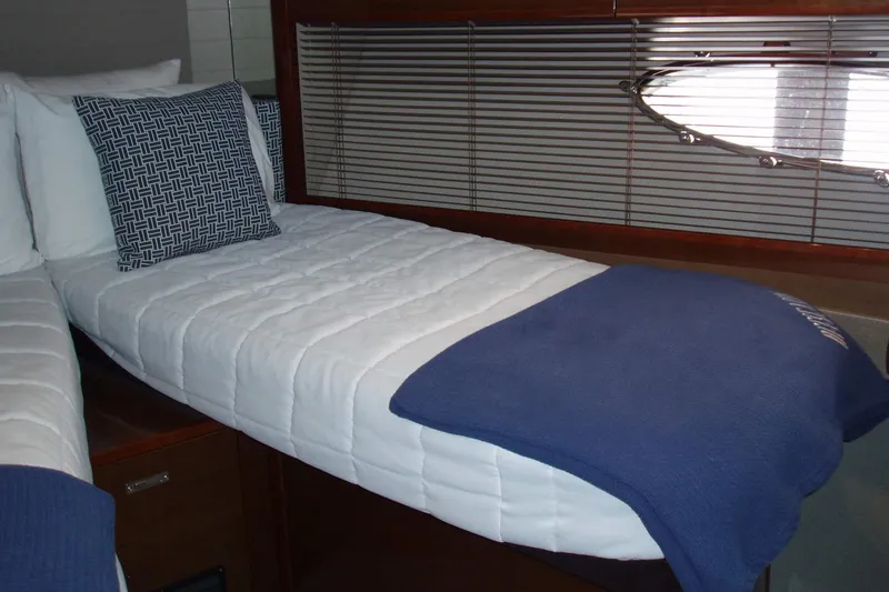 Off Season Yacht Photos Pics Luxurious cabin interior of 2015 Princess V48 yacht with cozy bedding.