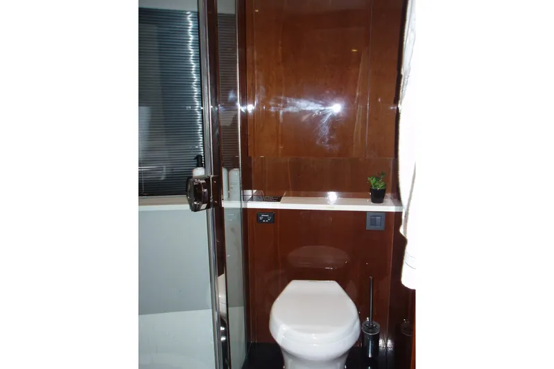 Off Season Yacht Photos Pics Luxurious bathroom in 2015 Princess V48 yacht with modern fixtures and wooden accents.
