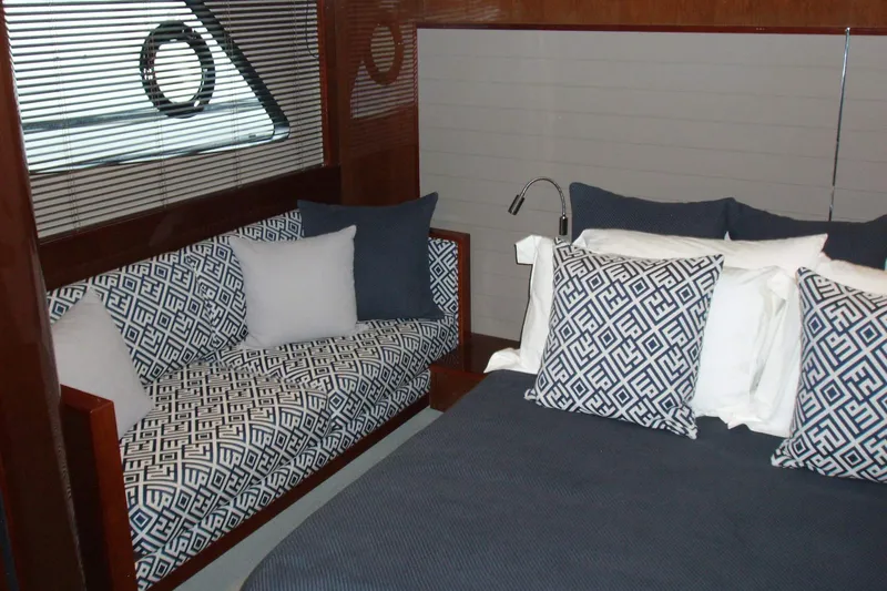 Off Season Yacht Photos Pics Luxurious interior of 2015 Princess V48 yacht with elegant bedding and seating.