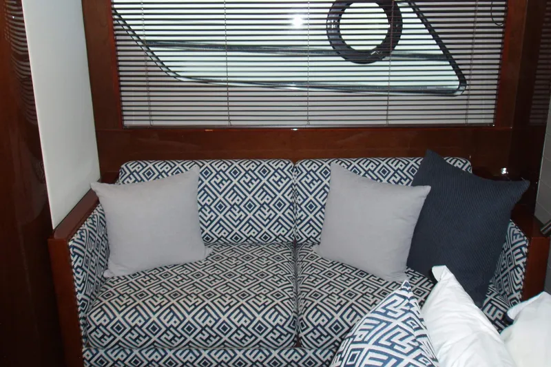 Off Season Yacht Photos Pics Luxurious interior of 2015 Princess V48 yacht with patterned sofa and cushions.