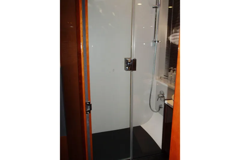 Off Season Yacht Photos Pics Shower area in 2015 Princess V48 yacht, featuring glass door and modern fixtures.