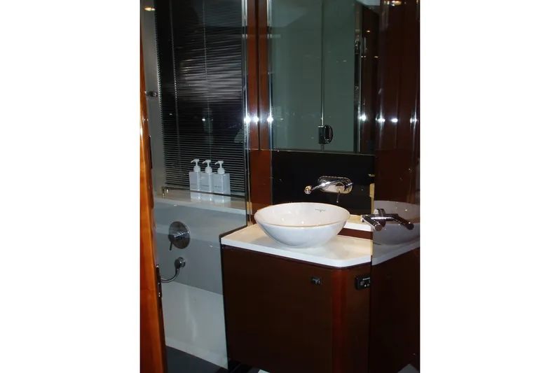 Off Season Yacht Photos Pics Luxurious bathroom in 2015 Princess V48 yacht with modern fixtures and elegant design.