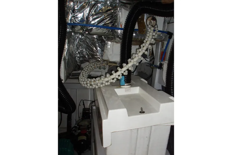 Off Season Yacht Photos Pics Engine room of 2015 Princess V48 yacht with mechanical components and wiring.