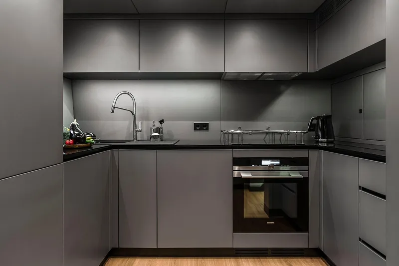  Yacht Photos Pics Modern kitchen interior on Sunreef 80 yacht, featuring sleek cabinetry and appliances, 2026 model.