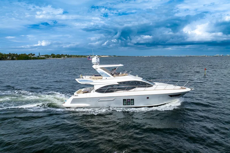 “just Chillin” Yacht Photos Pics 2014 Azimut 54 Flybridge yacht cruising on open water under a cloudy sky.