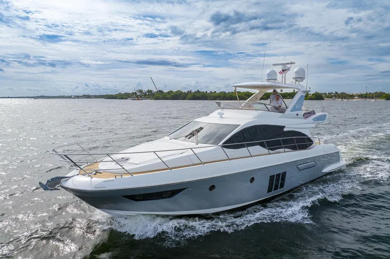 “just Chillin” Yacht Photos Pics 2014 Azimut 54 Flybridge yacht cruising on open water under a cloudy sky.