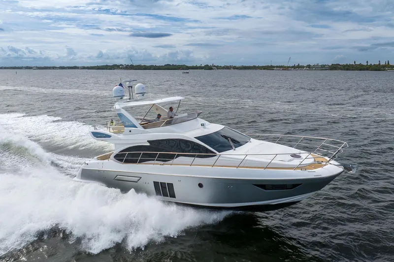 “just Chillin” Yacht Photos Pics 2014 Azimut 54 Flybridge yacht cruising on open water under a cloudy sky.