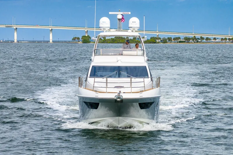 “just Chillin” Yacht Photos Pics 2014 Azimut 54 Flybridge yacht cruising on open water near a bridge.