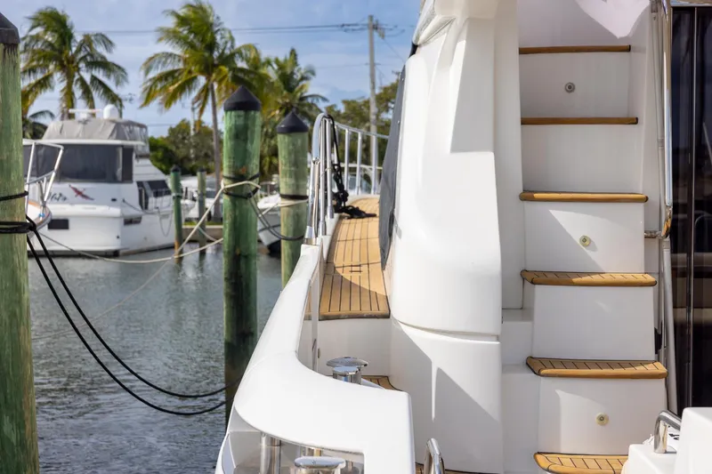 “just Chillin” Yacht Photos Pics 2014 Azimut 54 Flybridge yacht docked, featuring wooden steps and sleek design.