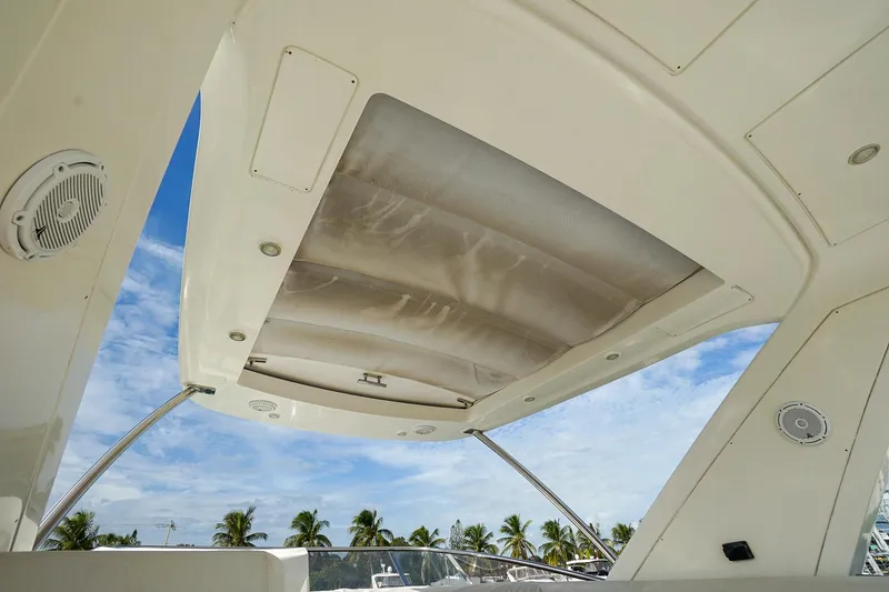“just Chillin” Yacht Photos Pics 2014 Azimut 54 Flybridge yacht ceiling with speakers, under a clear blue sky.