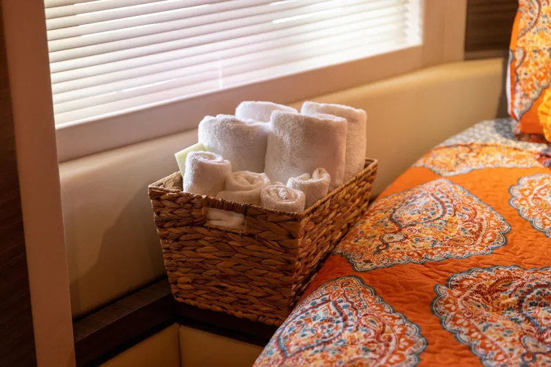 “just Chillin” Yacht Photos Pics Luxurious Azimut 54 Flybridge 2014 interior with basket of towels and vibrant bedding.