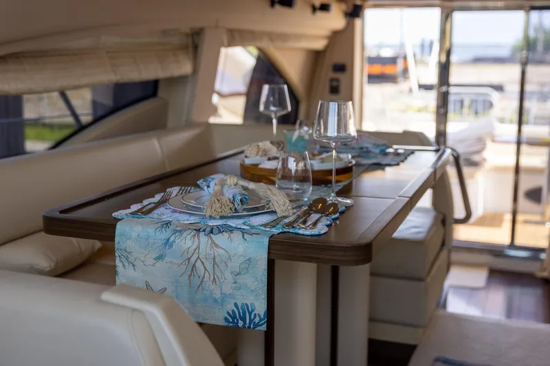 “just Chillin” Yacht Photos Pics Luxurious dining area on 2014 Azimut 54 Flybridge yacht, elegantly set table with ocean-themed decor.