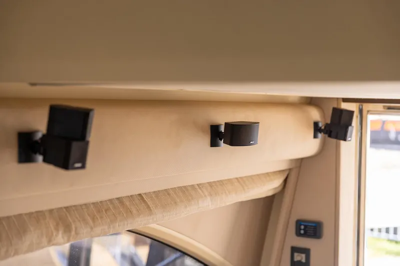 “just Chillin” Yacht Photos Pics Interior speakers on 2014 Azimut 54 Flybridge yacht, mounted on beige wall.