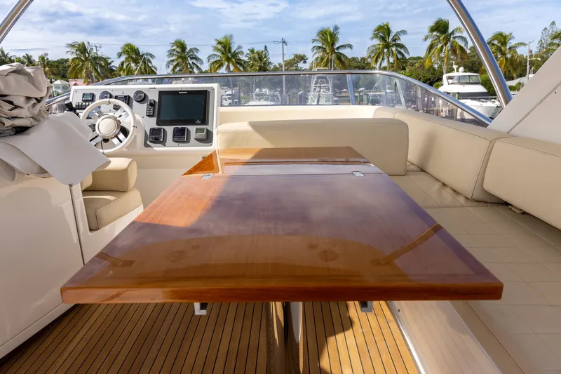 “just Chillin” Yacht Photos Pics 2014 Azimut 54 Flybridge yacht interior with polished wood table and modern helm controls.
