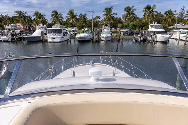 “just Chillin” Yacht Photos Pics View from Azimut 54 Flybridge yacht, 2014 model, overlooking marina with palm trees and boats.
