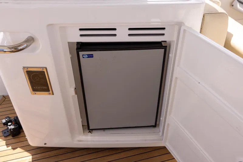 “just Chillin” Yacht Photos Pics Built-in fridge on 2014 Azimut 54 Flybridge yacht, open door, teak deck visible.
