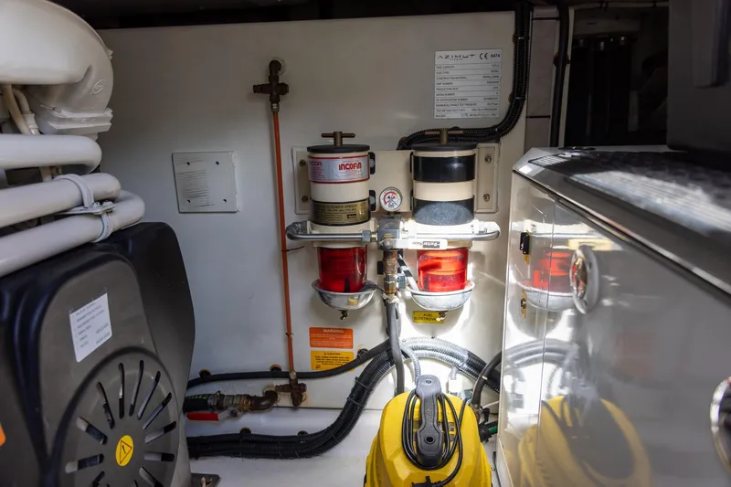 “just Chillin” Yacht Photos Pics Engine room of 2014 Azimut 54 Flybridge yacht, showcasing fuel filters and machinery.