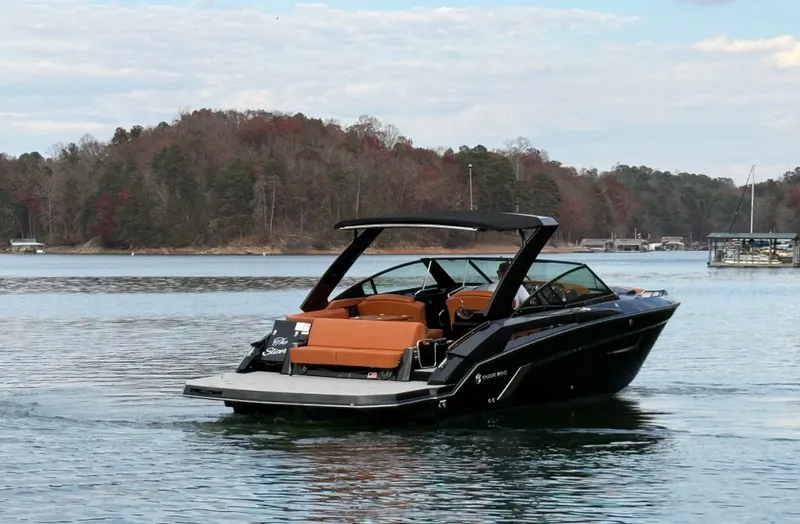  Yacht Photos Pics 2022 Cruisers Yachts 338 CX SB on a serene lake with forested shoreline.